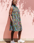 The model is wearing black, yellow, blue, red, pink print dress