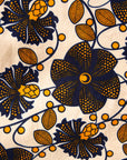 Close up display of navy, black, off white, yellow flower print dress