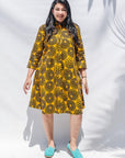 The model is wearing black, yellow print dress