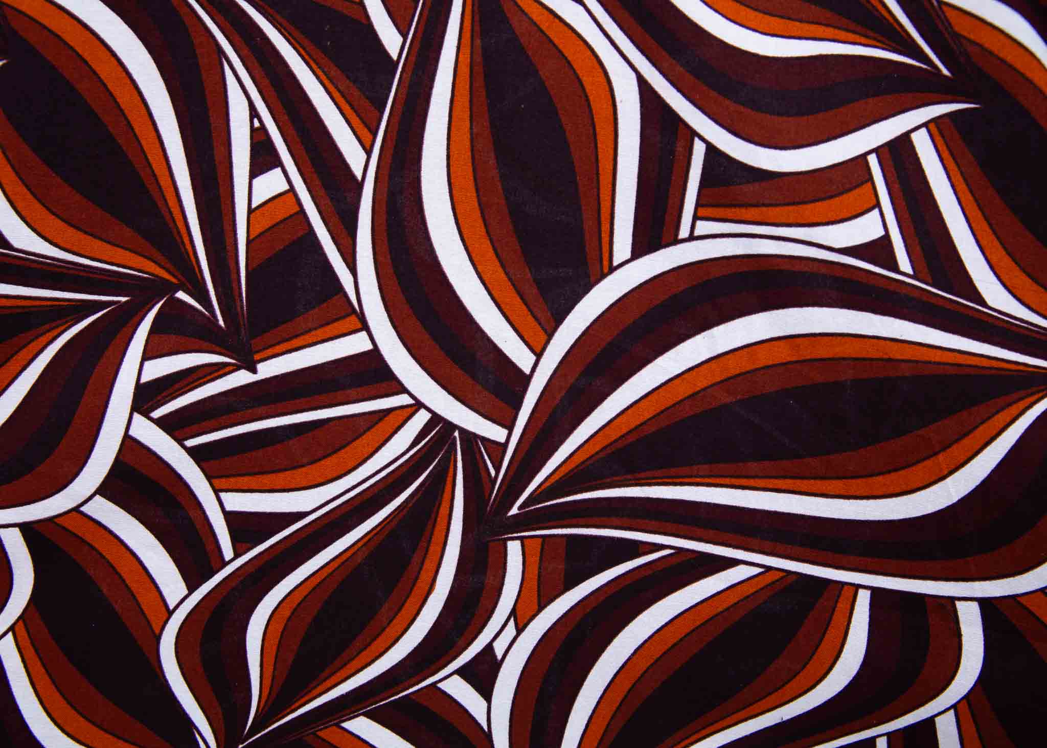 Display of brown, orange, and white abstract print dress.