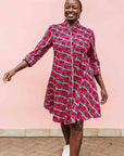Model wearing red and pink geometric print dress.