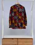 Display of multicolored puzzle print shirt.