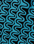 Close up display of blue and black squiggle print dress, fabric.