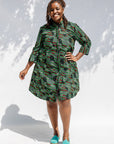 Model wearing green camo print like dress.