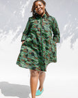 Model wearing green camo print like dress.