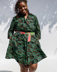 Model wearing green camo print like dress.
