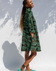 Model wearing green camo print like dress.
