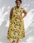 Model wearing yellow and black sleeveless maxi dress.