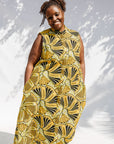 Model wearing yellow and black sleeveless maxi dress.