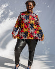 Model wearing multicolored puzzle print shirt.
