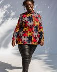 Model wearing multicolored puzzle print shirt.