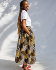 Model wearing brown leaf print culotte bottoms.