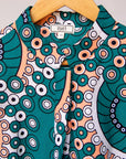 Display of teal, white, black and peach dress with gears