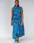 Model wearing blue dress with beige fish print.
