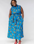 Model wearing blue dress with beige fish print.