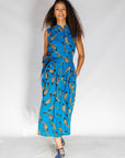 Model wearing blue dress with beige fish print.