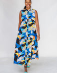Model wearing blue dress with yellow, black, orange and white geometric print.