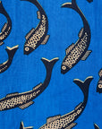 Close up display of blue pants with beige fish print, fabric.