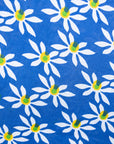 White flowers with green centers on a blue background