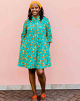 model wearing a teal, orange and yellow pod design dress