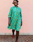 model wearing a teal, orange and yellow pod design dress