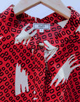 display of a red, white and black squiggle design dress