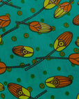 Display of a teal, orange and yellow pod design dress