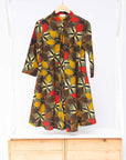 The display of brown, yellow, red and black leaf print dress.