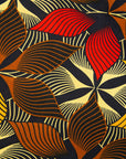 Close up display of brown, yellow, red and black leaf print, fabric.