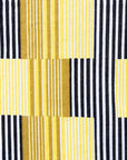 Close up display of yellow and black striped dress.