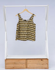 Display of mustard and black triangle print tank.
