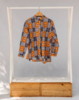 Display of orange, navy and white geometric print shirt.