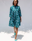 Model wearing green and blue floral batik dress.