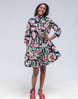 Model wearing colorful abstract print dress.