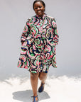 Model wearing colorful abstract print dress.