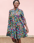 The model is wearing multi colored dress with disco ball print