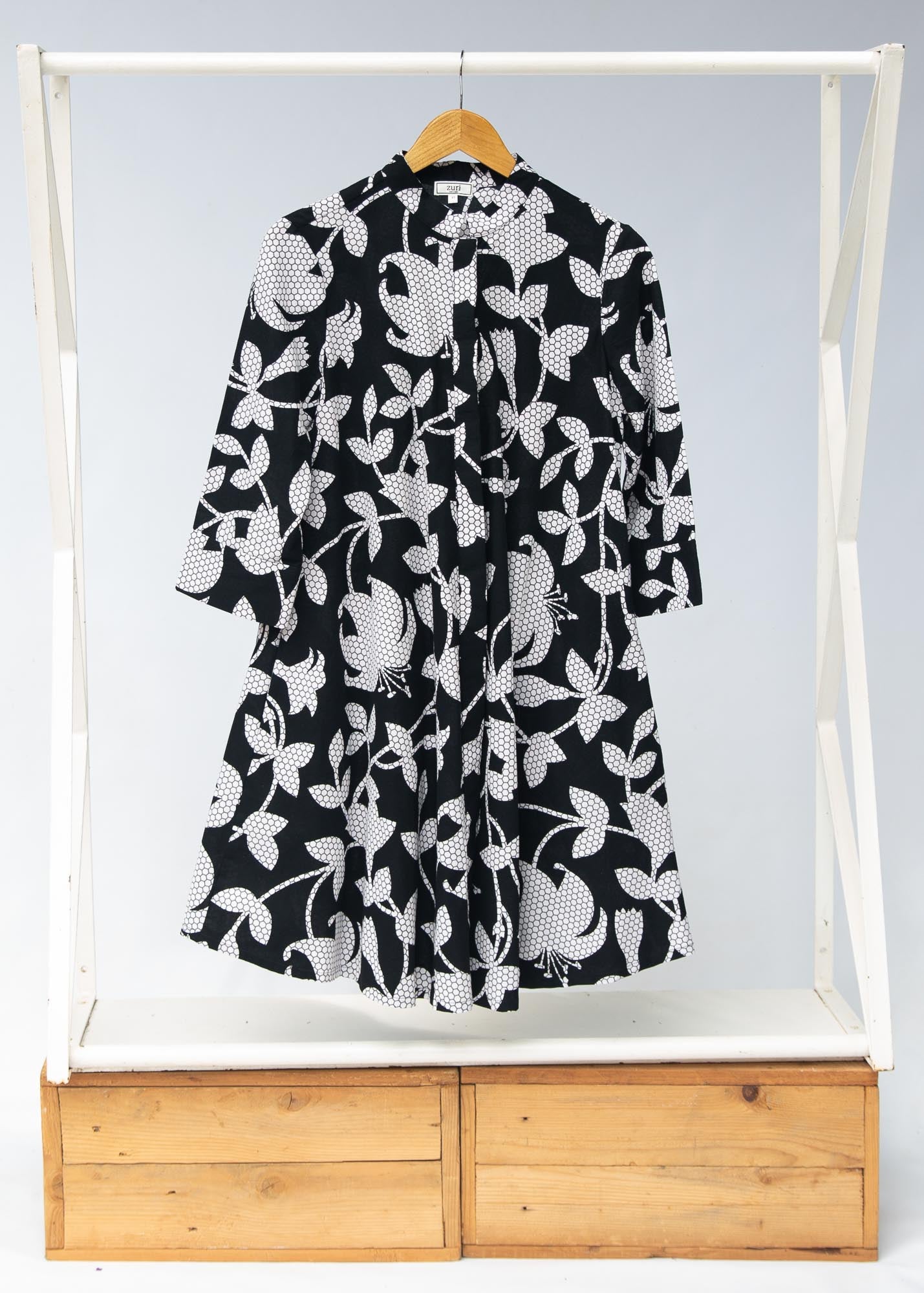 Display of  black dress with white and gray leaf print