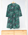 Display of black, green and white geometric print dress
