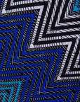 Close up display of blue, aqua and white zig zag print dress, fabric.