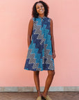 Model wearing blue, aqua and white zig zag print dress.