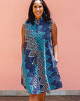 Model wearing blue, aqua and white zig zag print dress.