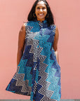Model wearing blue, aqua and white zig zag print dress.