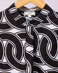 Close up display of black and white chain link shirt.