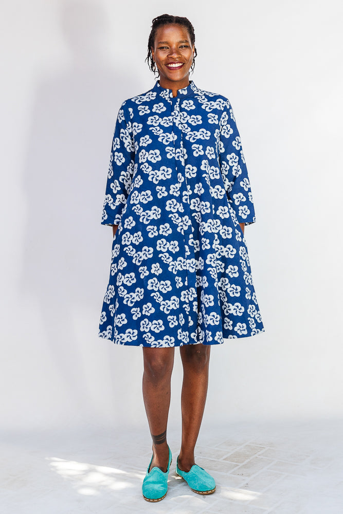 Model wearing blue and white floral dress.