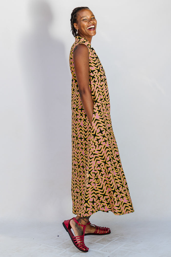 Model wearing beige, yellow and black geometric print dress.