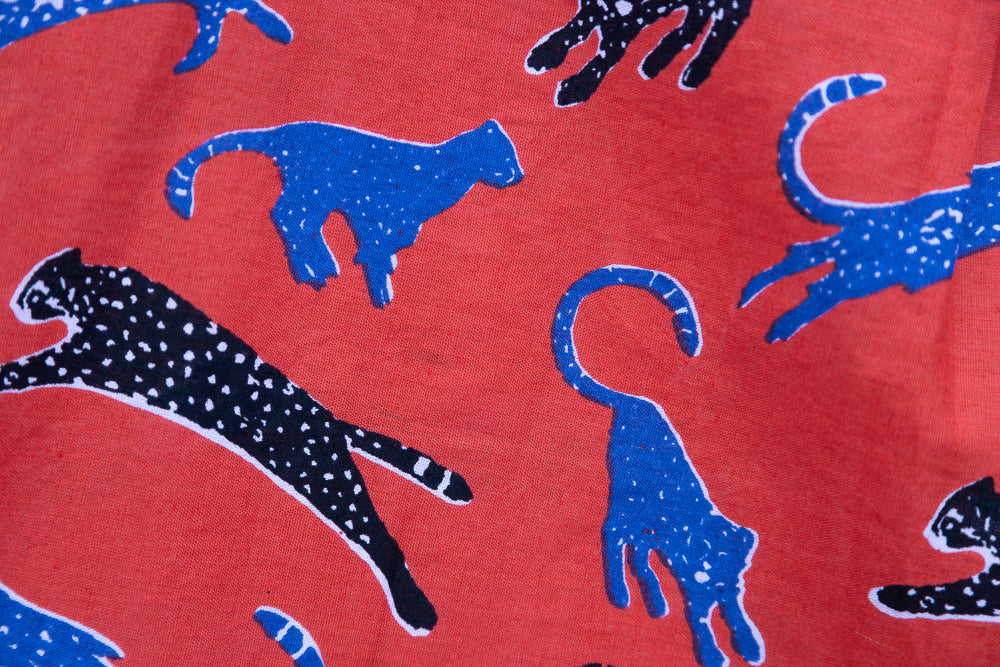 Close up display of red cat print dress, fabric.
