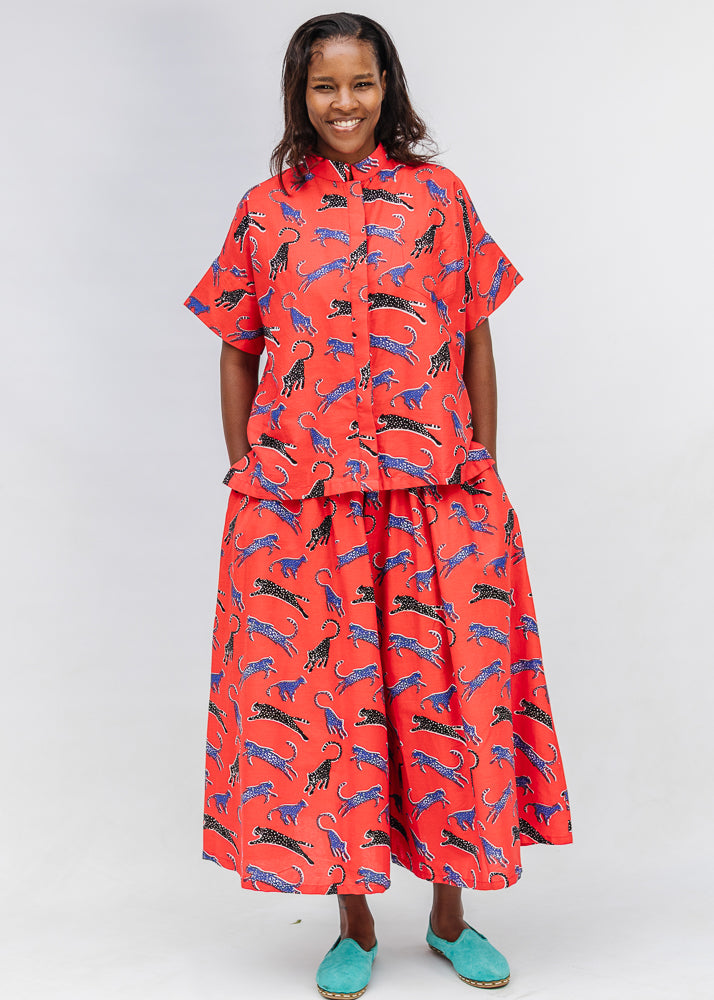 Model wearing red cat print shirt and culotte.