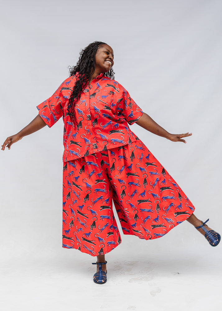 Model wearing red cat print shirt and culotte.