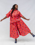 Model wearing red cat print shirt and culotte.