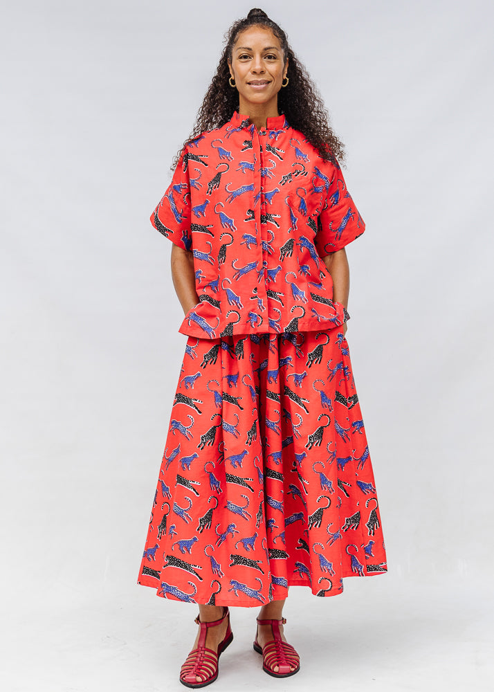 Model wearing red cat print shirt and culotte.